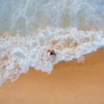 man walking beach