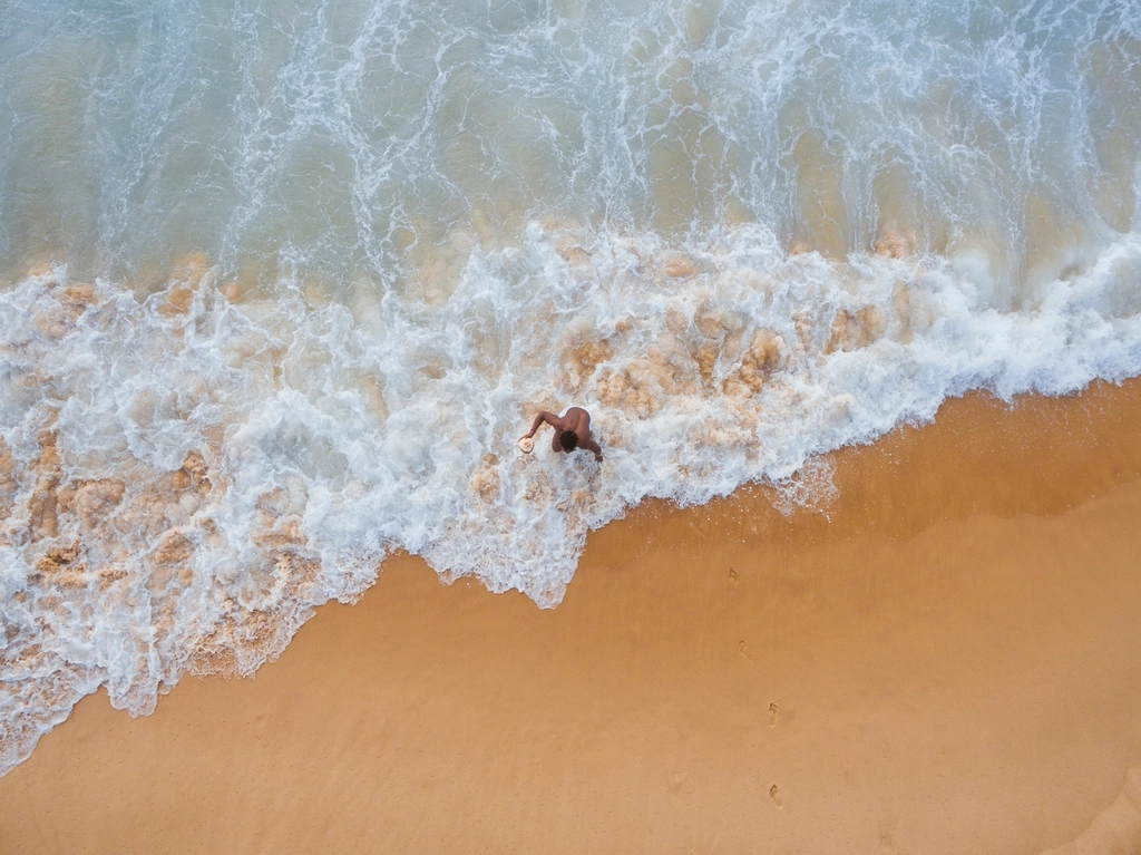 man walking beach